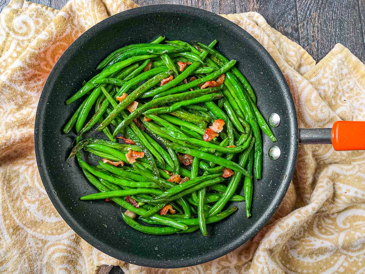 pan with bacon bits and green beans