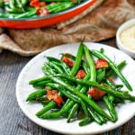pan and white plate with ow carb green beans and bacon and text