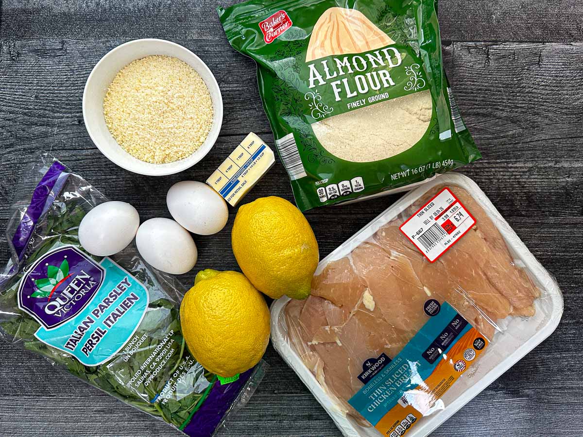 Recipe ingredients - thin sliced chicken, almond flour, grated romano cheese, eggs, butter, lemon, parsley.