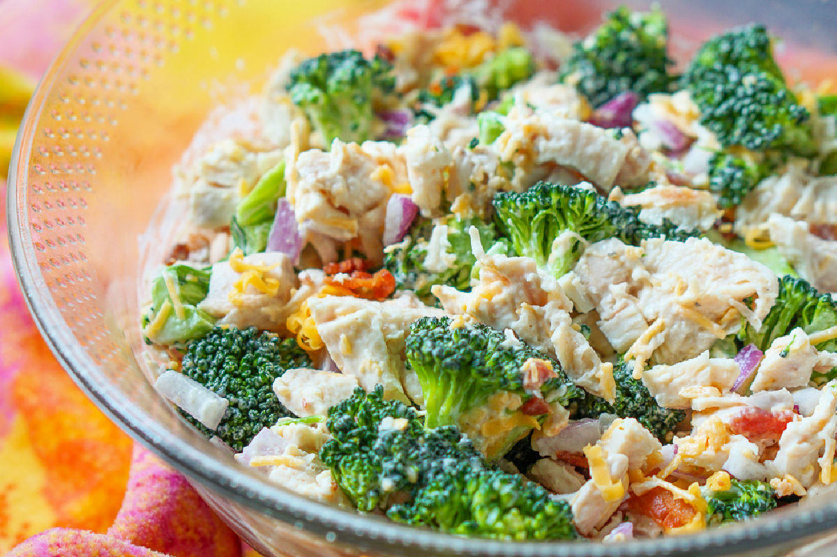 Closeup of a glass bowl with the high protein low carb broccoli chicken salad with ranch and bacon.