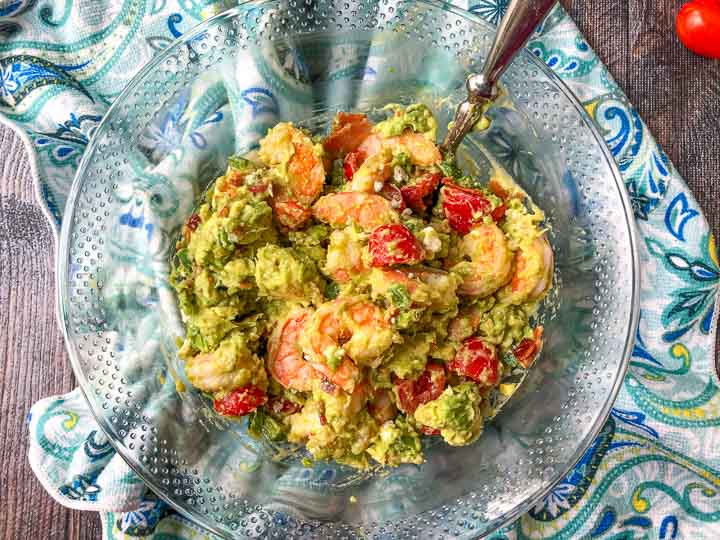 glass bowl of low carb avocado shrimp salad on blue tea towel