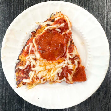 spaghetti squash pizza slice on white plate