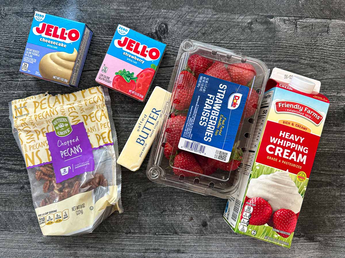Recipe ingredients - pecans, butter, strawberry jello, cheesecake pudding, butter and heavy cream.