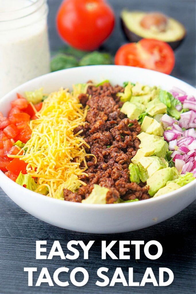 aerial view of keto taco salad with keto ranch dressing and fresh tomatoes, garlic and herbs and text