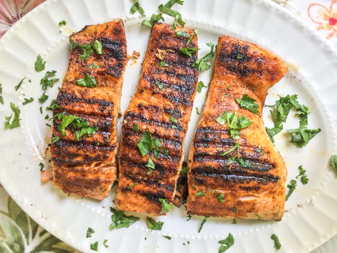 This low carb bbq salmon is easily made indoors and has a creamy garlic herb sauce to top it off. A low carb bbq rub on the salmon is spicy and sweet and the creamy sauce is a cooling compliment to the dish.