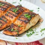 This low carb bbq salmon is easily made indoors and has a creamy garlic herb sauce to top it off. A low carb bbq rub on the salmon is spicy and sweet and the creamy sauce is a cooling compliment to the dish.