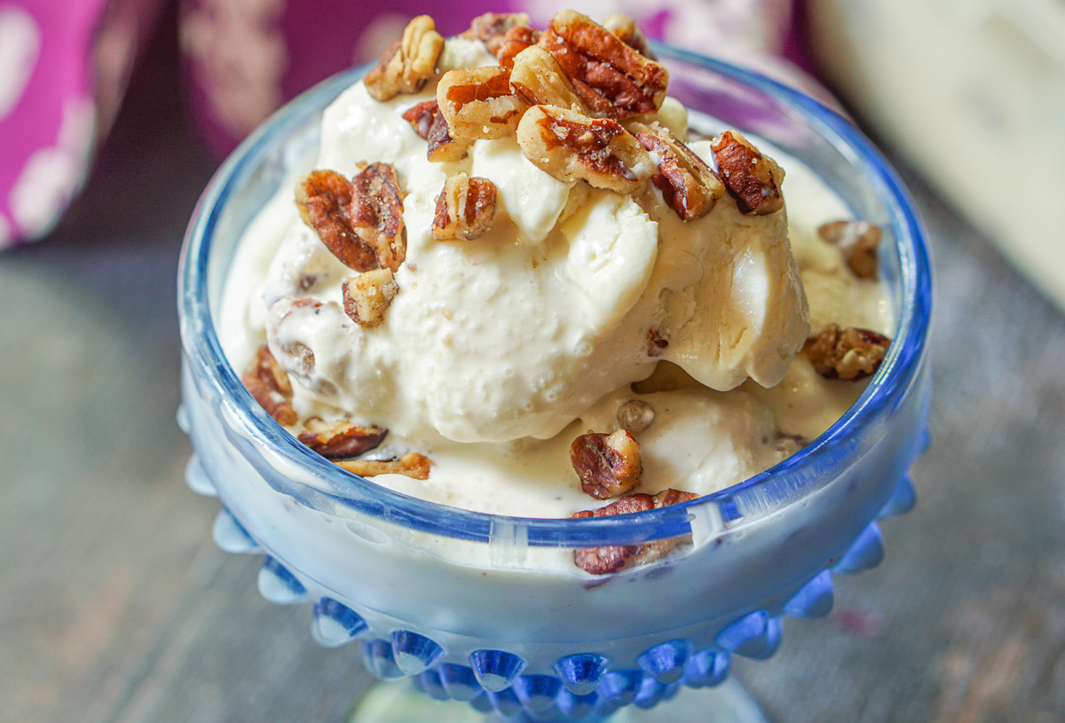 closeup of ice cream dish with butter pecans on top