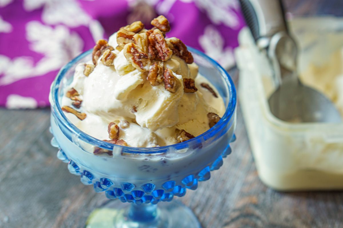 blue dish with sugar free ice cream topped with nuts