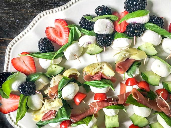 These easy caprese kebabs are a fun and healthy appetizer or even a low carb snack for summer. Using a variety of fruits and vegetables with fresh mozzarella and basil and a drizzle of balsamic glaze for a fresh summer bite.
