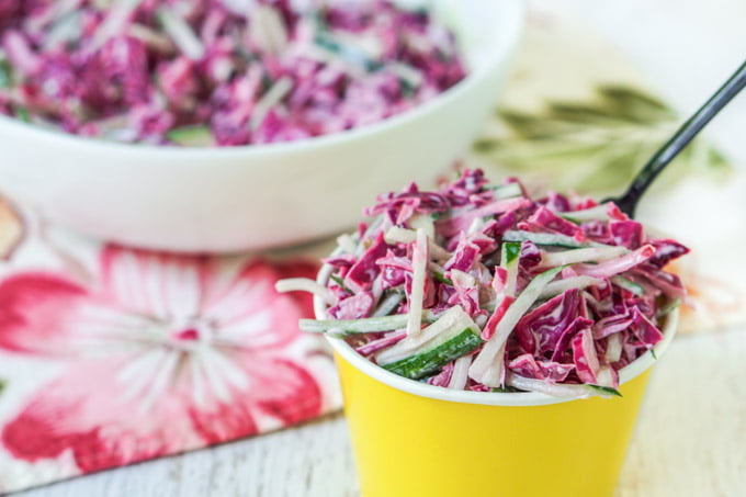 yellow cup with purple cabbage and cucumber slaw