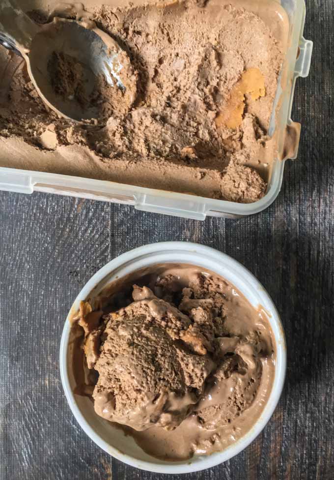 Long picture of chocolate peanut butter container and scoop.