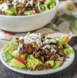 This low carb Philly cheesesteak salad is the answer to your cheesesteak cravings. It's easy to make. The savory meat mixture over crunchy and cool lettuce are topped with a creamy Parmesan dressing. Only 5.3g per serving.
