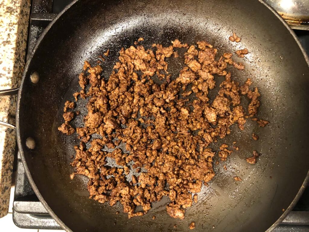 skillet with spicy ground beef cooking