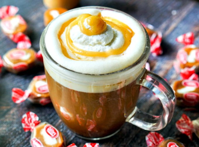 closeup of keto salted caramel cream low carb coffee drink with scatter caramel cream candies