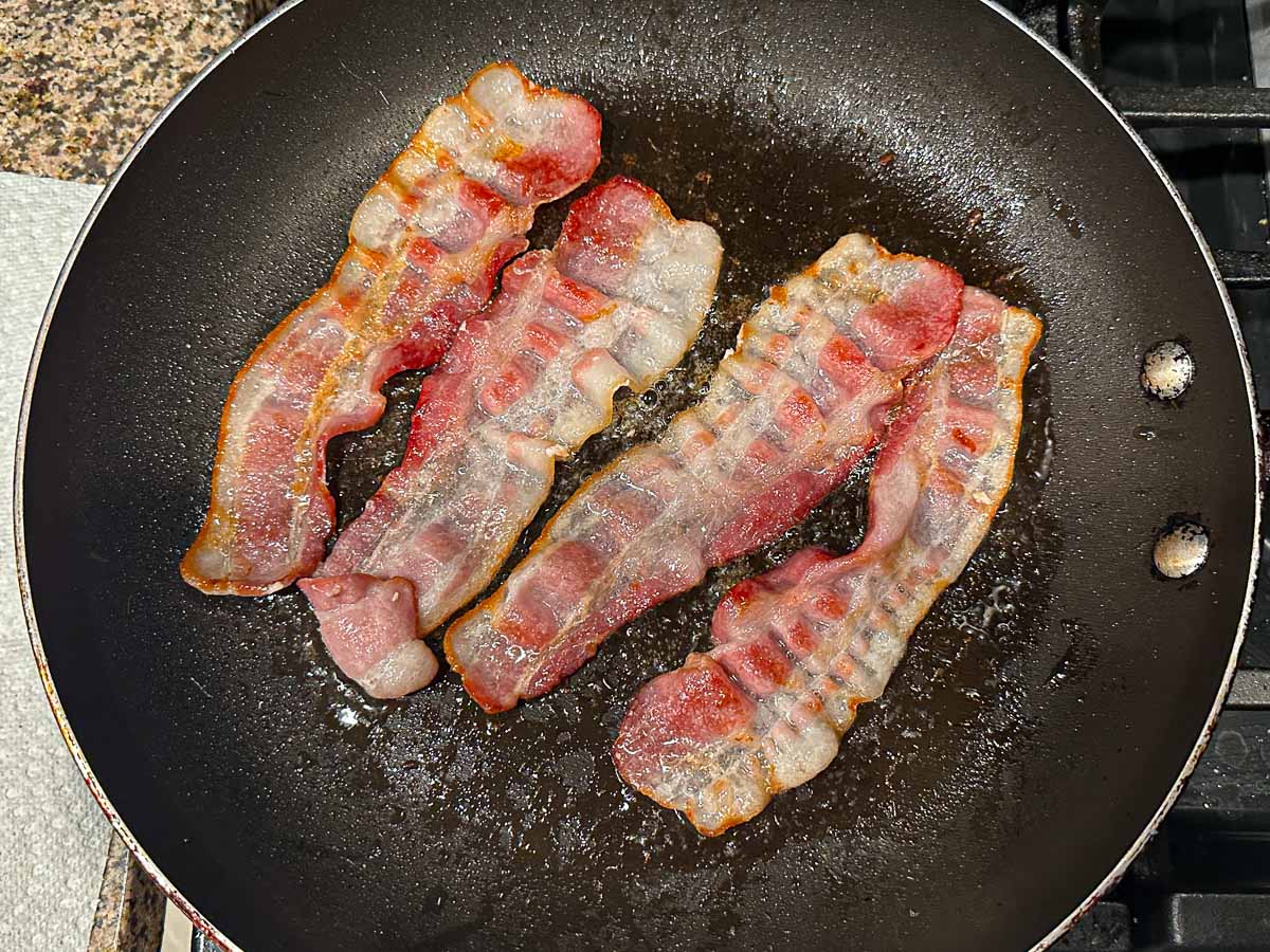 Skillet with 4 pieces of bacon.