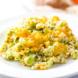 white plate with keto cheesy broccoli cauliflower rice