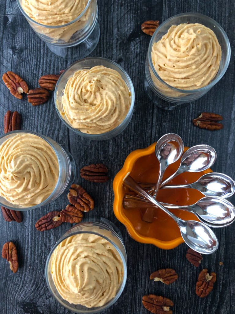 aerial view of glass dishes with no bake cheesecake and silver mini spoons