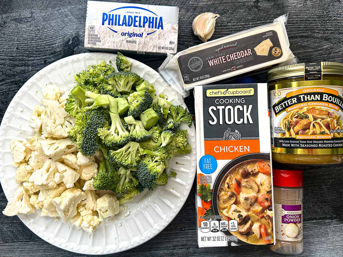 Recipe ingredients - raw broccoli, raw cauliflower, chicken broth, better than bouillon, onion powder, creamy cheese and sharp cheddar cheese.
