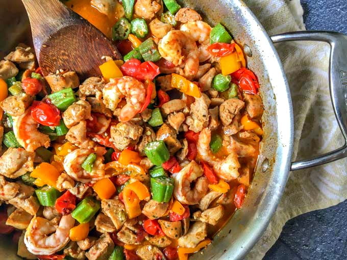 This low carb cajun stir fry dinner is full of flavorful ingredients like chicken, shrimp and sausage. You can make this one pan dinner in under 30 minutes and there is just 5.1g net carbs per serving!