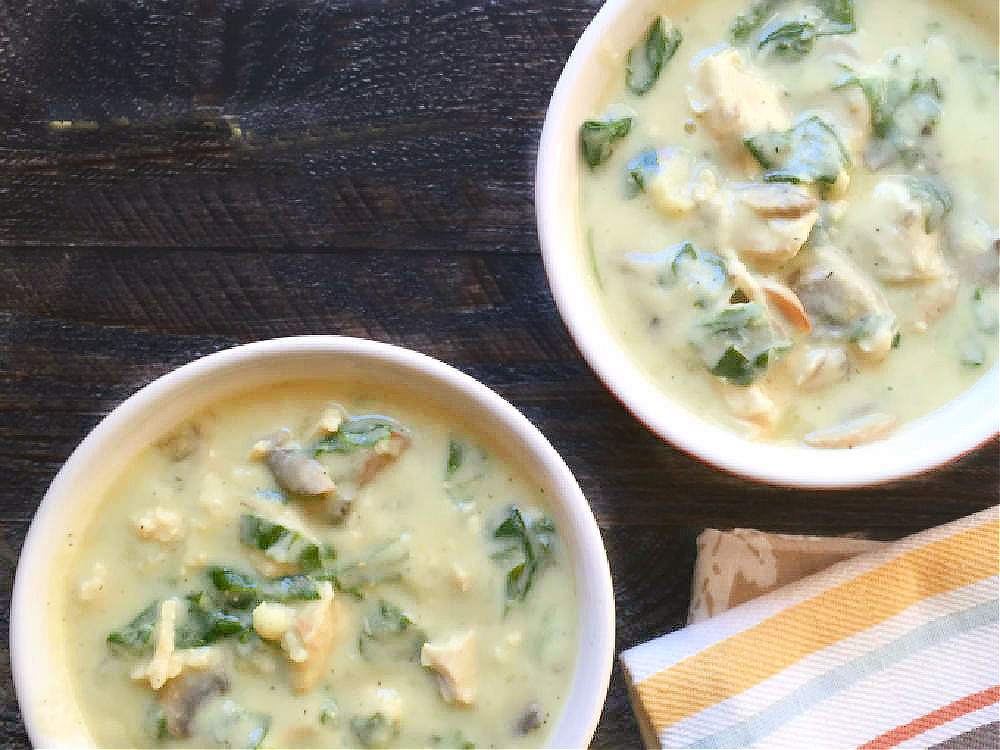 aerial view of 2 crocks of creamy spinach soup