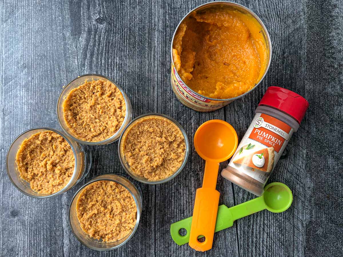 4 keto pumpkin mini desserts with measuring spoons and pumpkin pie spice