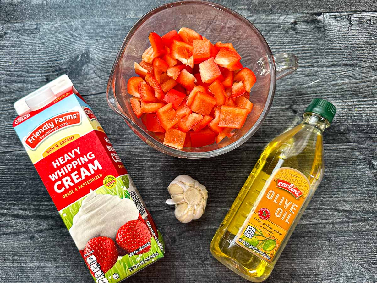 Recipe ingredients - chopped peppers, garlic, olive oil and heavy cream.