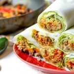 red plate with fajita lettuce wraps stacked