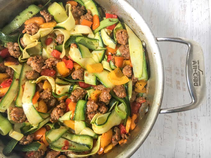 This meal of wide zucchini noodles with sausage & peppers is a delicious and easy low carb pasta dish for any day of the week. One serving has 196 cals and 6.4g net carbs. 