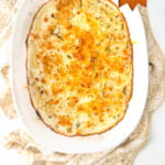 white baking dish with keto cauliflower au gratin and text overlay