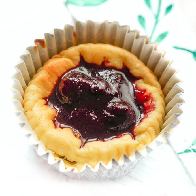 closeup of a mini keto blueberry cheesecake  in a foil wrapper