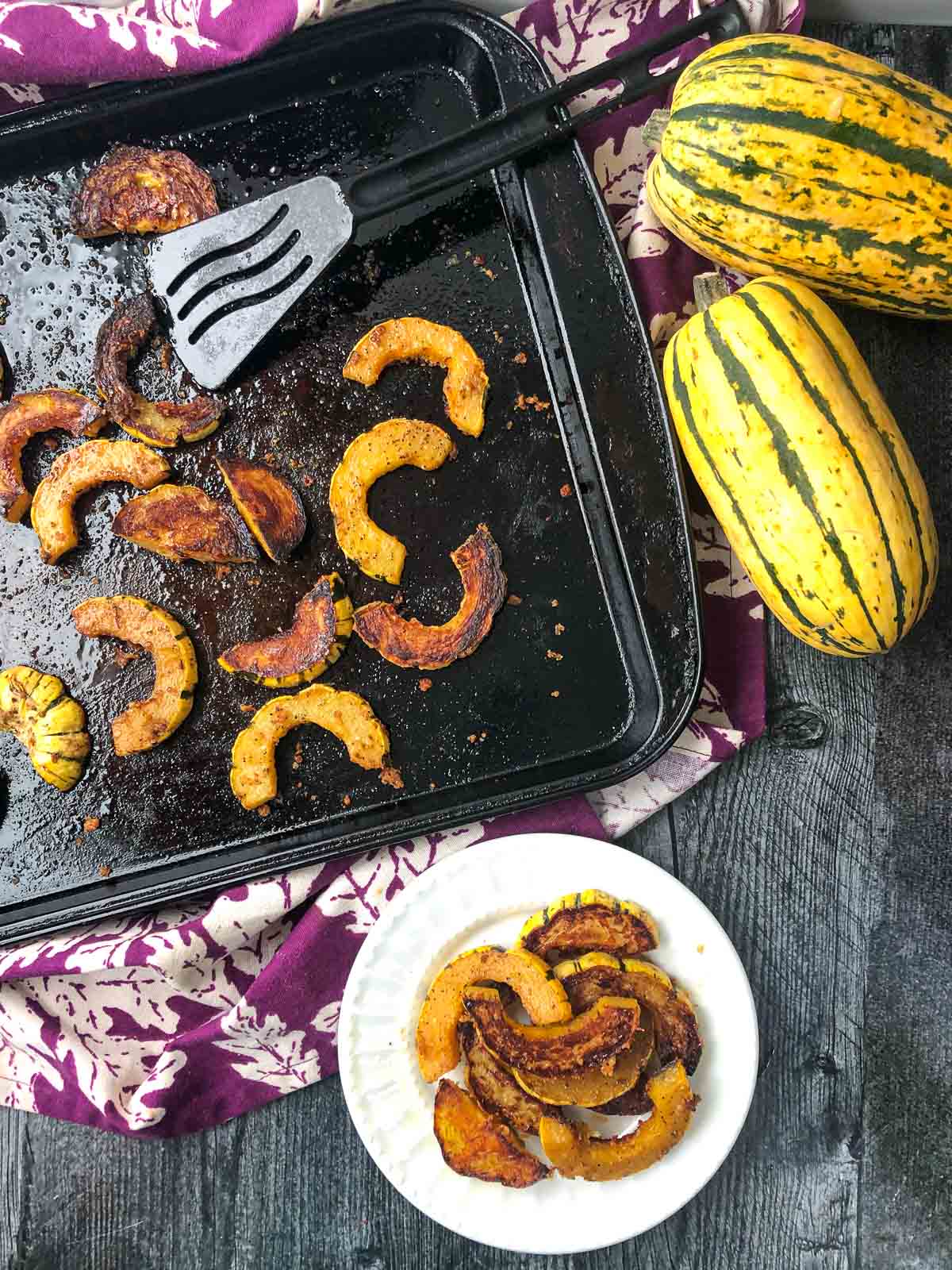 aerial view of baking sheet with delicata fries and two Delicata Squash