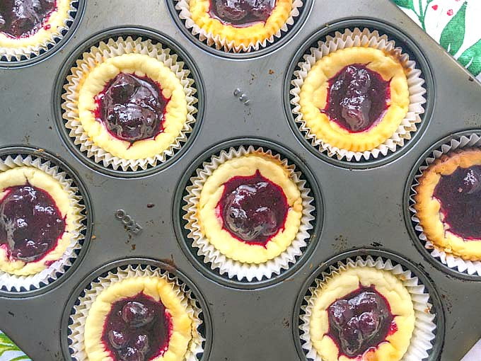 These low carb cheesecake tarts are topped with a sweet and tart blueberry sauce and are perfect for the holiday season. With a few ingredients you can easily make these tasty bite size treats to take to a party or to have on hand for yourself. 