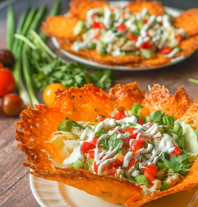 These low carb keto chicken nachos taste great as a taco salad to0! Making chips and taco shells out of cheese is the perfect vehicle for making Mexican dishes such as these. Either as nachos or a taco salad there is only 2.6g net carbs!