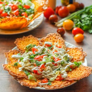 These low carb keto chicken nachos taste great as a taco salad to0! Making chips and taco shells out of cheese is the perfect vehicle for making Mexican dishes such as these. Either as nachos or a taco salad there is only 2.6g net carbs!