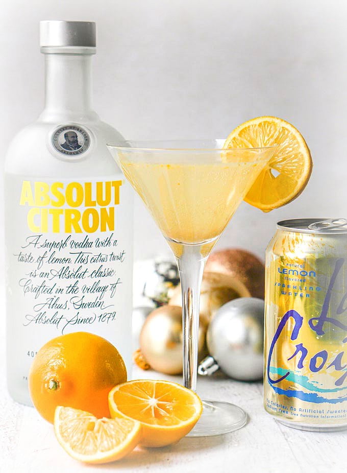 low carb lemon drop martini with cut Meyer lemon and Absolut vodka bottle and LaCroix seltzer can