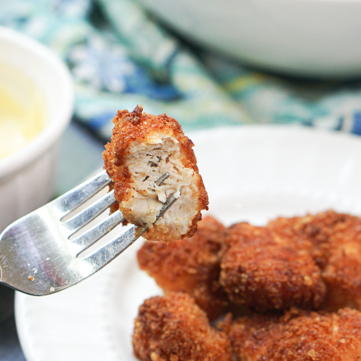 white plate with keto chicken nuggets and a fork