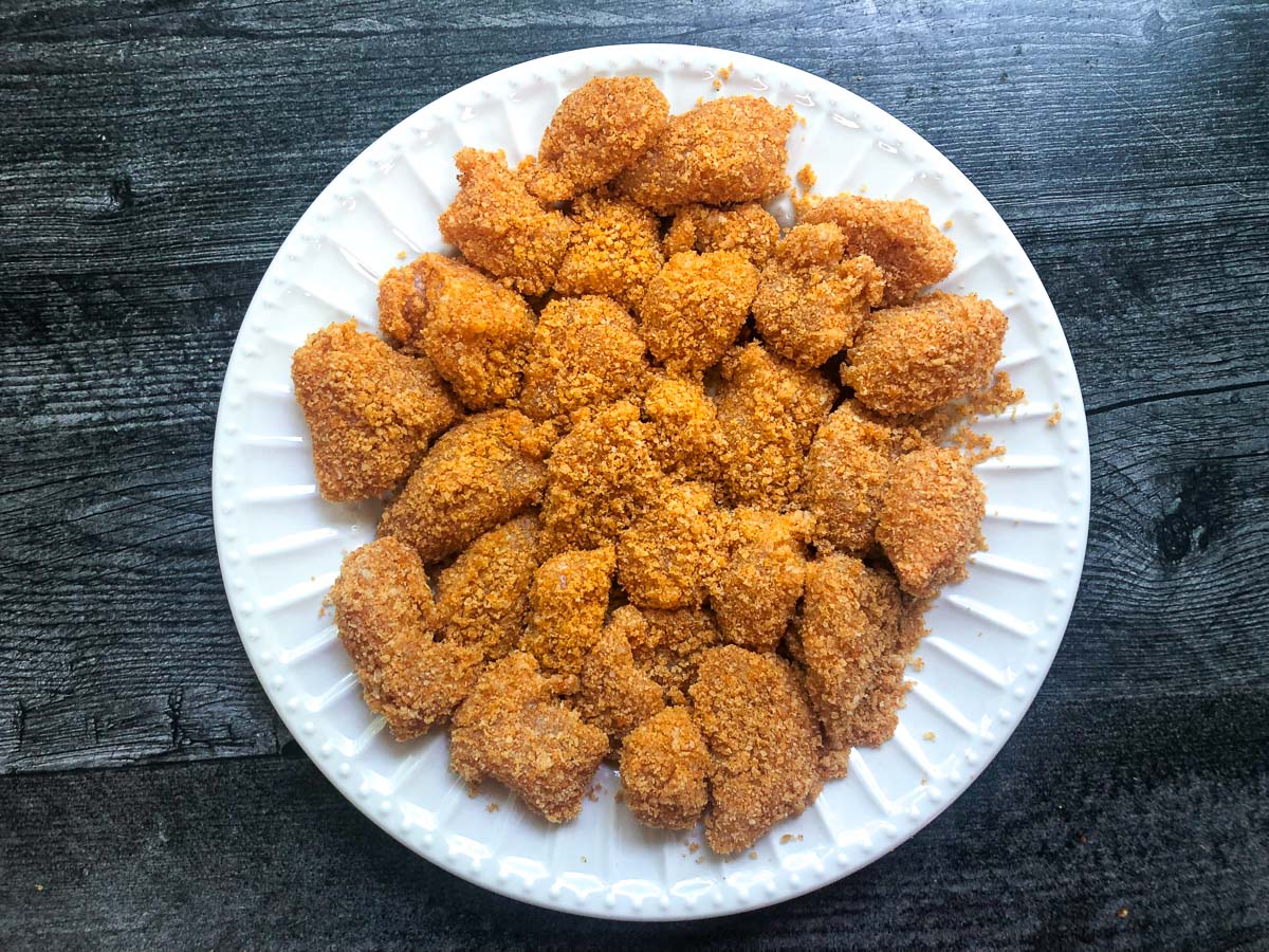white plate with breaded pieces of chicken ready to air fry