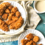 white plate with fried gluten free chicken tenders with text overlay