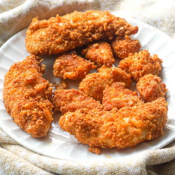 white plate with fried gluten free chicken tenders