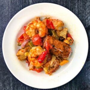 white plate with keto cajun sausage and shrimp s heat pan dinner