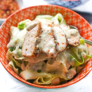 Bowl with zucchini noodles, chicken and keto alfredo sauce.