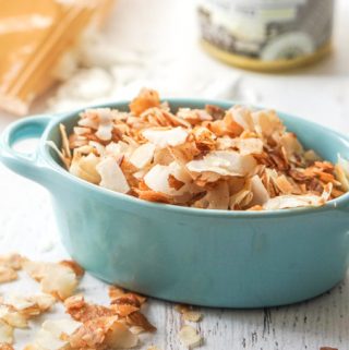 Photo of coconut chips in a blue bowl.