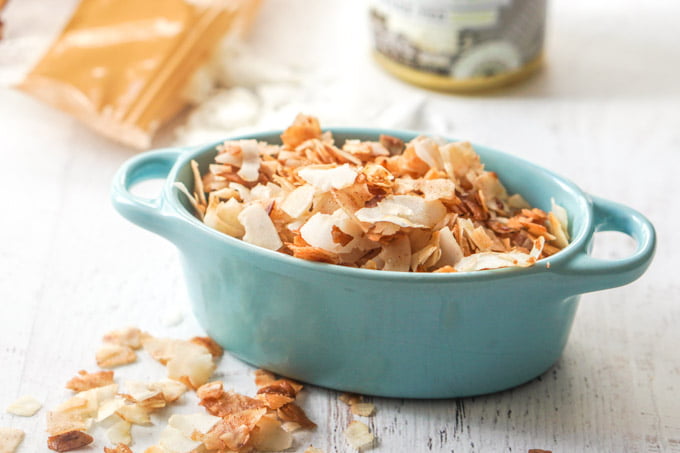 Photo of coconut chips in a blue bowl.