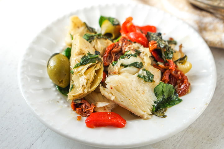 white plate with low carb Mediterranean fish dinner