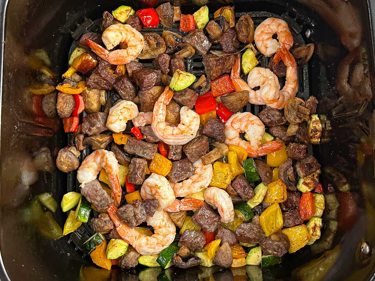 Air fryer basket with the finished dish.