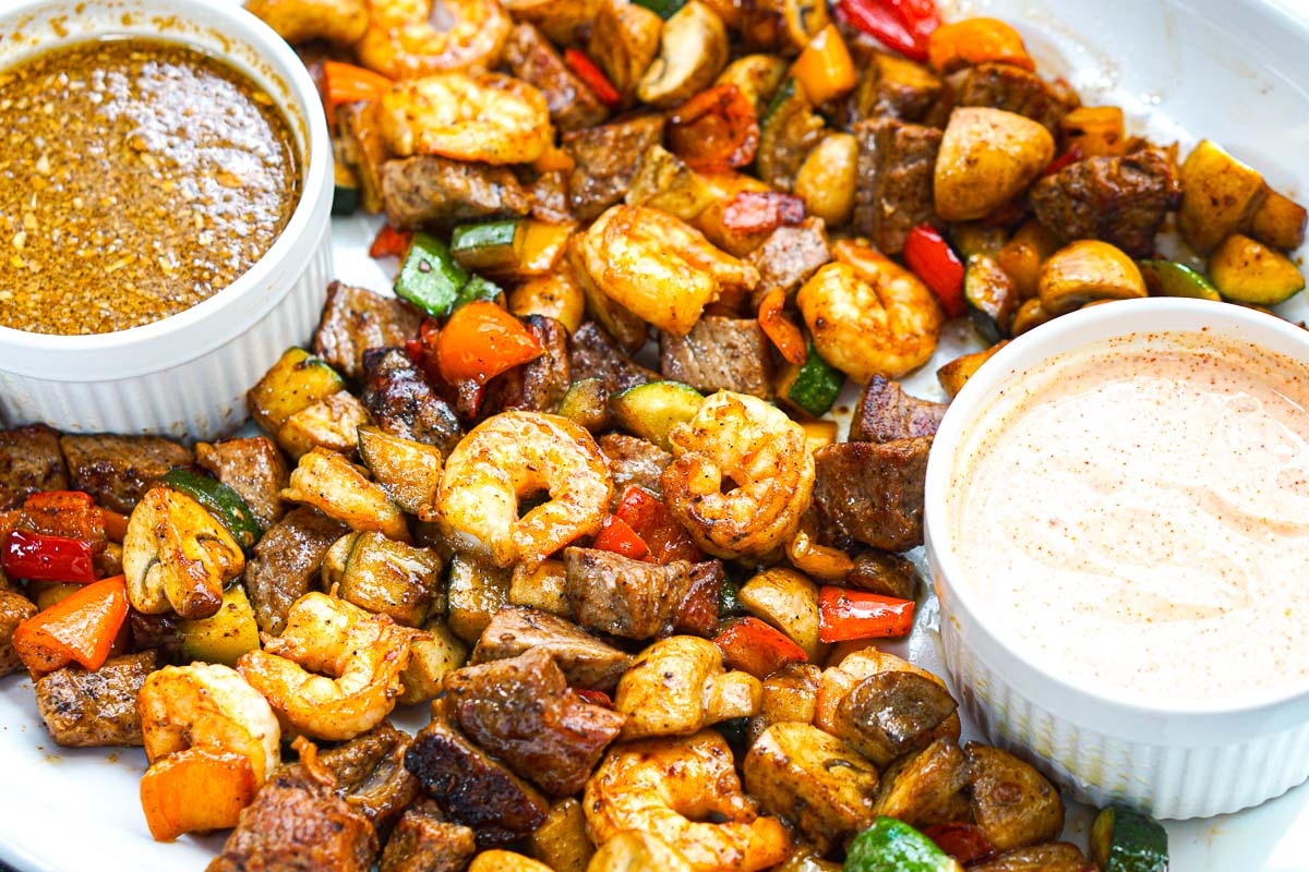 White platter with the finished dish and dipping sauces.