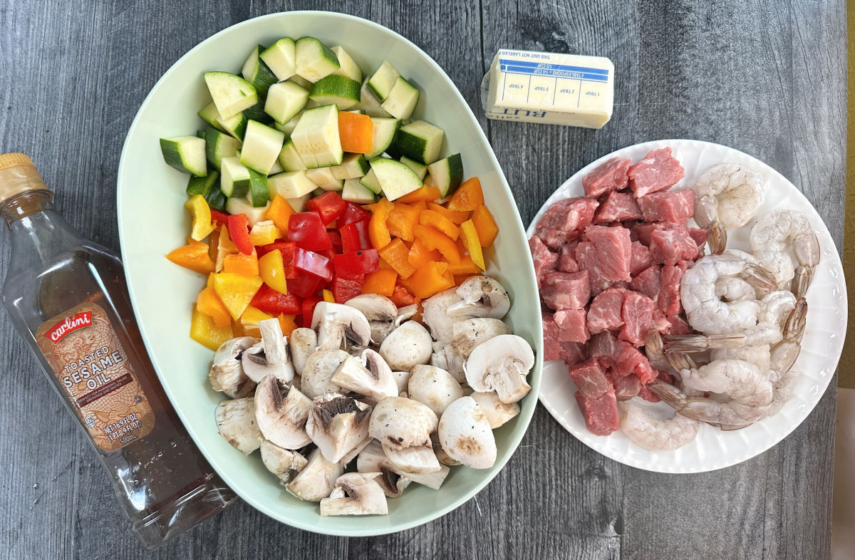 Recipe ingredients - butter, sesame oil, shrimp, beef, chopped veggies.