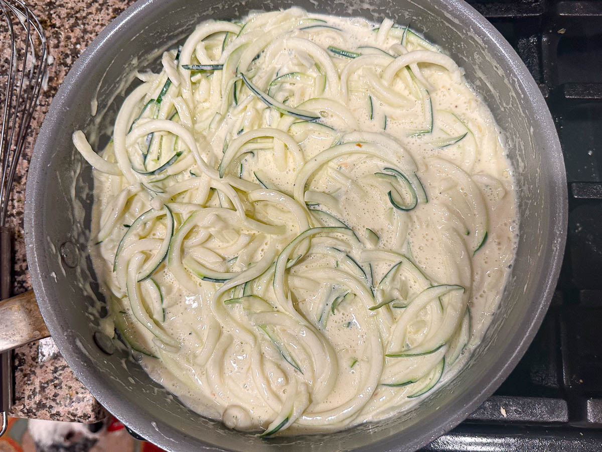 pan with sauce and zucchini