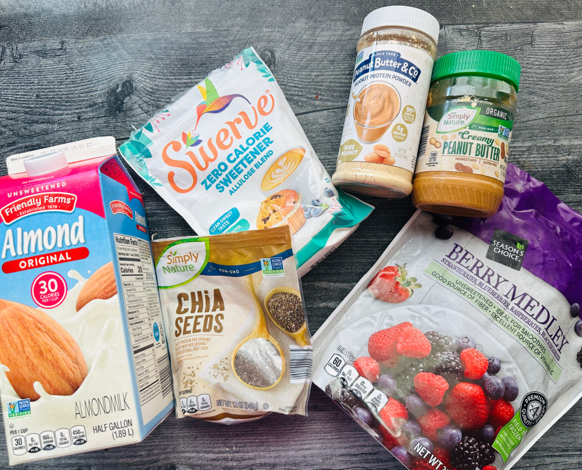 Recipe ingredients - almond milk, chia seeds, frozen berries, sweetener, peanut butter and powdered peanut butter.