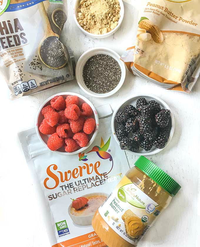 photo of peanut butter, peanut butter powder, chia seeds, raspberries and blackberries